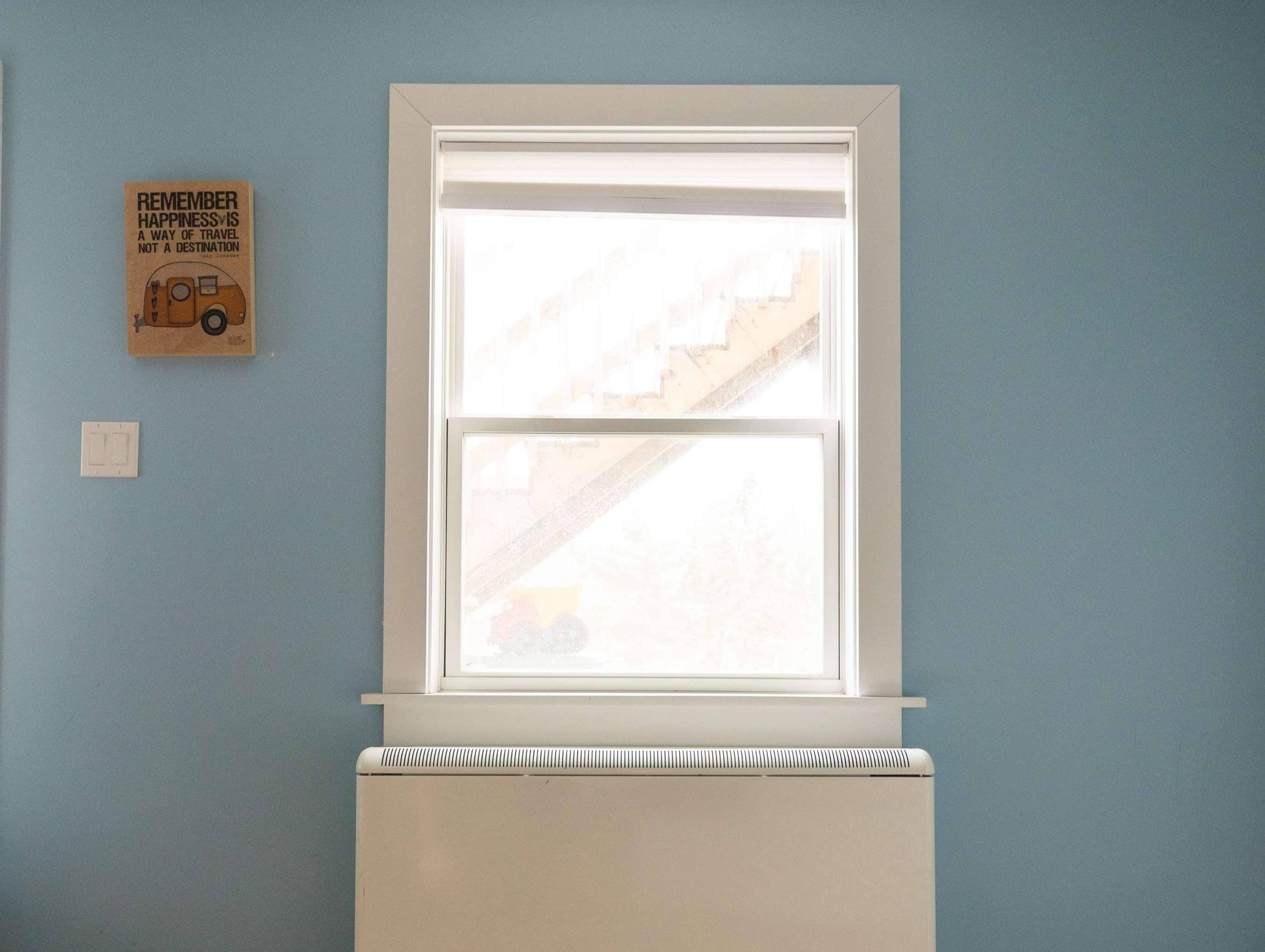 Electric thermal storage unit located in a room under a window.