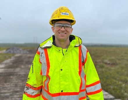 A male Nova Scotia power employee in safety gear outside