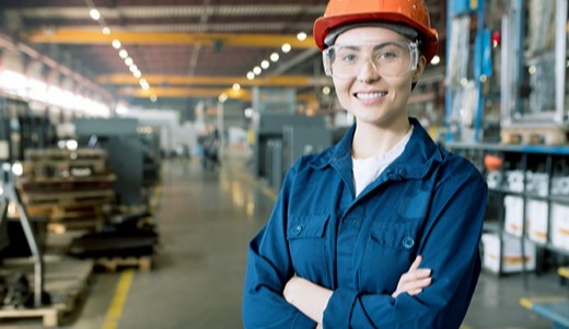 A female engineer at NSP crossing her arms and smiling